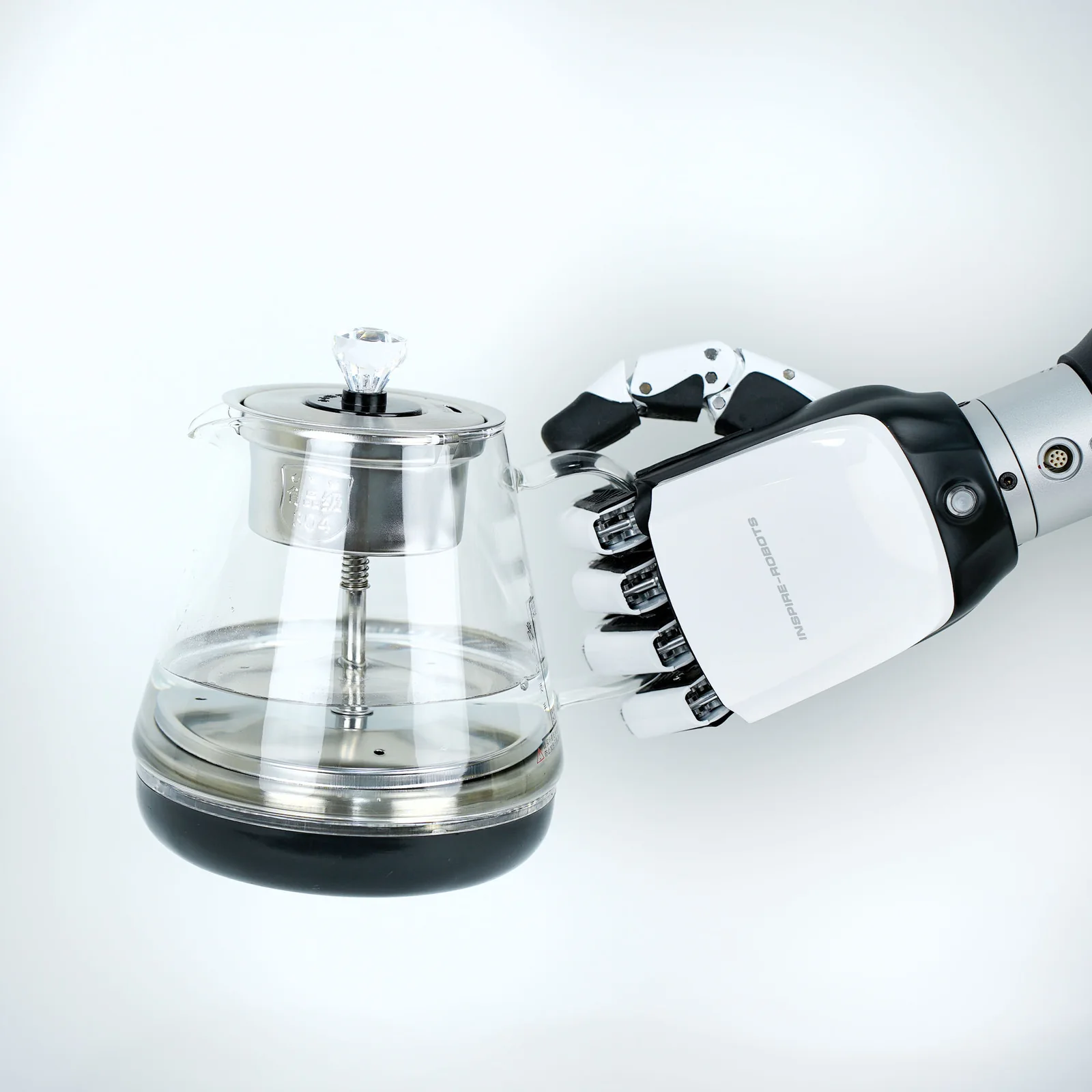 Hand RH56E2 am Roboterarm hält eine Glaskanne am Griff (Herstellerfoto)